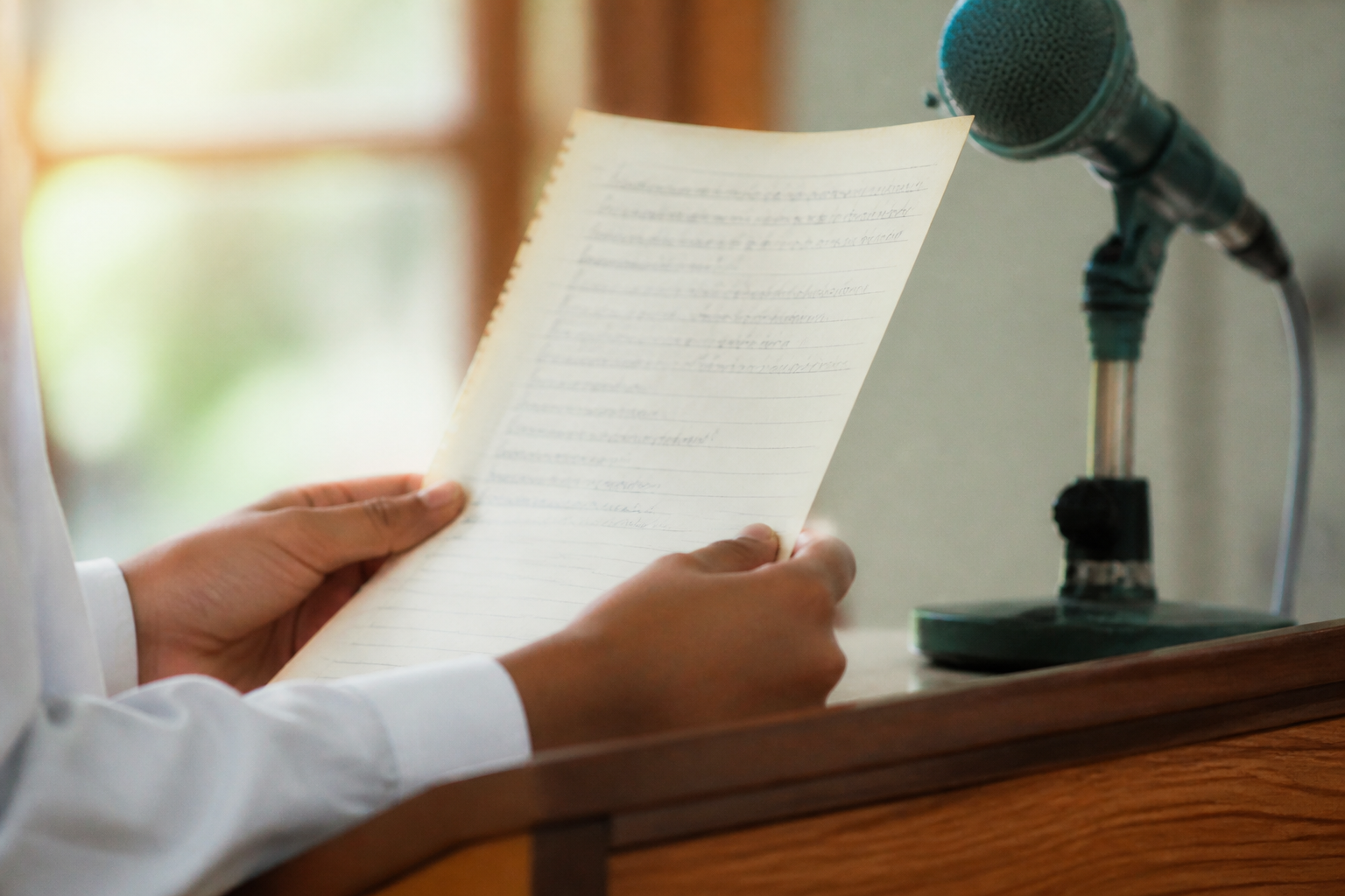 A child holding speech notes at a podium